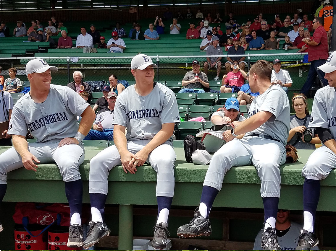 Baseball players near the dugout